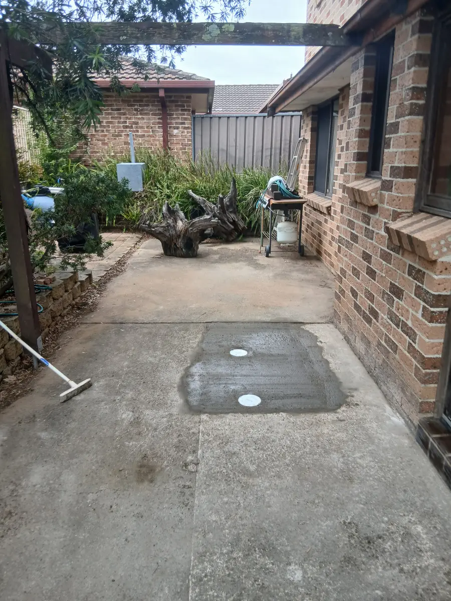 Concrete courtyard with a newly installed in-ground drainage point