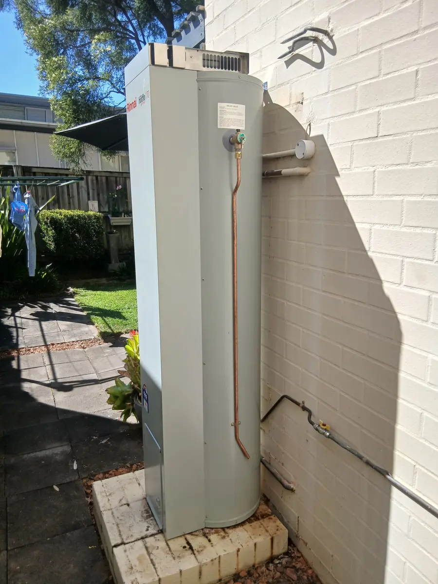 Rinnai gas storage hot water unit newly installed on an outdoor brick plinth